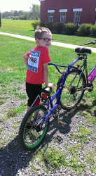 Tracy: My Shark loving 7 yr old.  He just finished his biking to earn his medal.